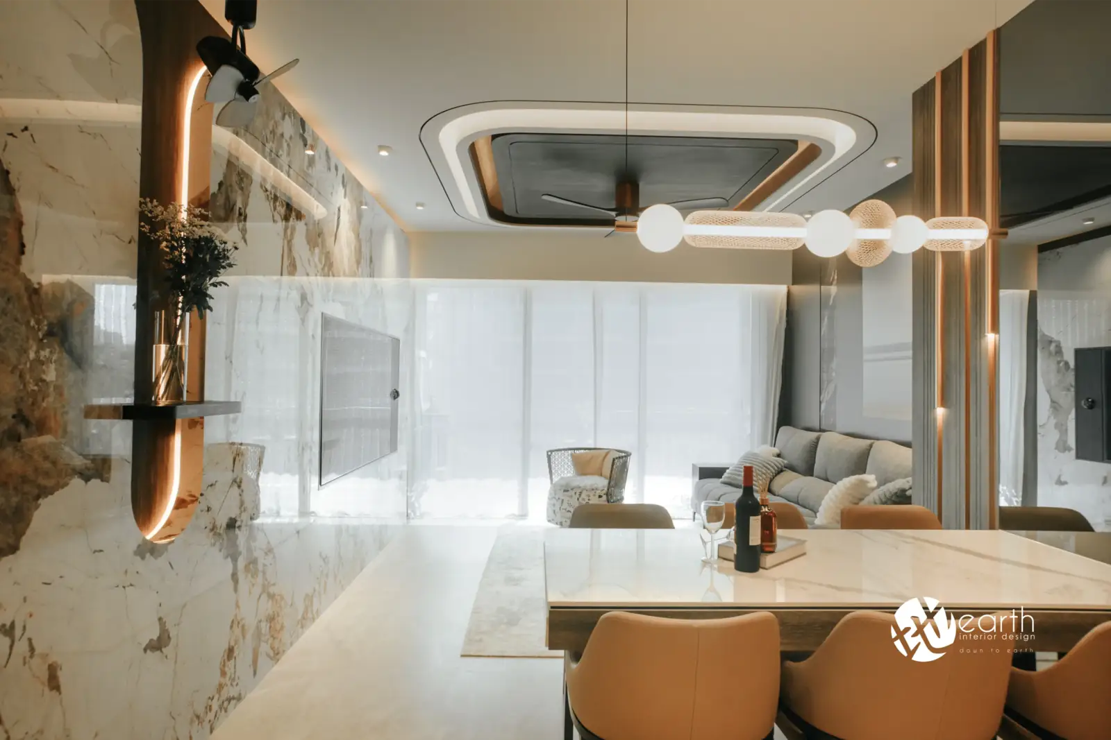 Dining area with a marble feature wall and pendant lights at Harbourfront Avenue by Earth Interior Design