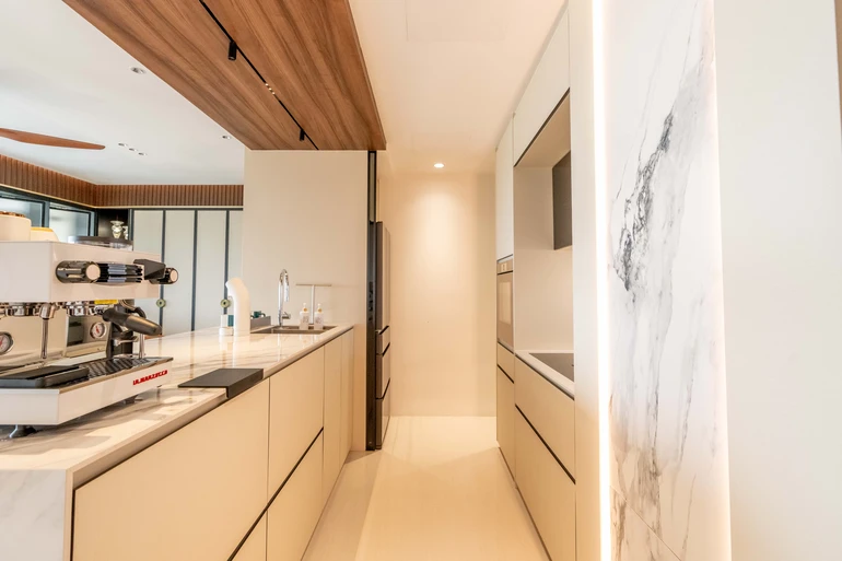 Minimalist kitchen island featuring sleek white cabinetry and a marble countertop.