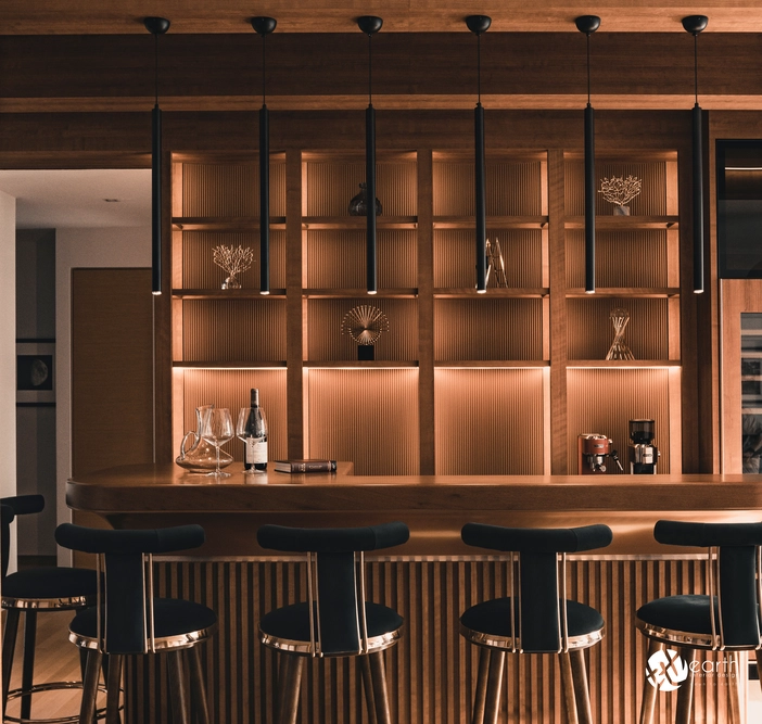 Kitchen island with warm lighting and a sophisticated wooden finish, perfect for hosting.